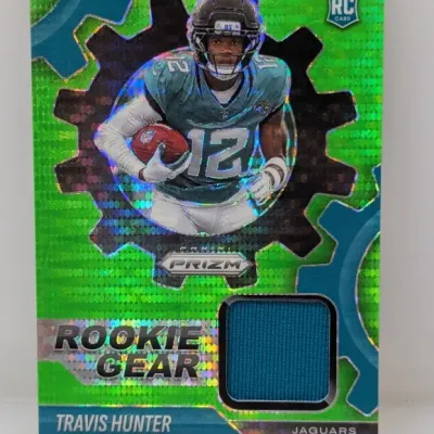 Panini Prizm Rookie Gear Travis Hunter football card featuring a green pulsar parallel design and an embedded jersey relic swatch.