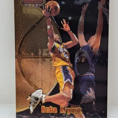 1996-97 Bowman's Best Kobe Bryant rookie basketball card featuring a refractor finish and dynamic action photo.