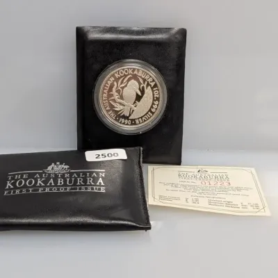 1990 Australian Kookaburra First Proof Issue 1 oz .999 fine silver coin, complete with black display case, outer pouch, and certificate...