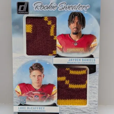 Panini Donruss Rookie Sweaters dual memorabilia trading card featuring Jayden Daniels and Luke McCaffrey of the Washington Commanders.