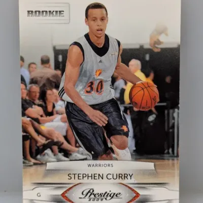 2009 Panini Prestige Stephen Curry rookie basketball card, featuring the Golden State Warriors guard in action.