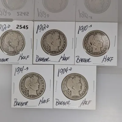 Collection of five early 20th-century US Barber half dollars, individually mounted in cardboard flips with handwritten dates and mint...