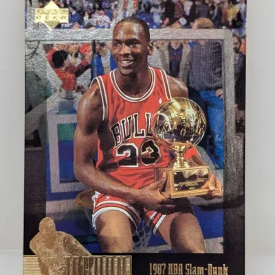 Upper Deck Michael Jordan '1987 NBA Slam-Dunk Champion' trading card with foil embossed details.