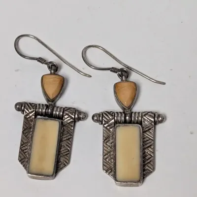 Pair of Southwest style sterling silver drop earrings with inlaid stone accents and French hook wires.