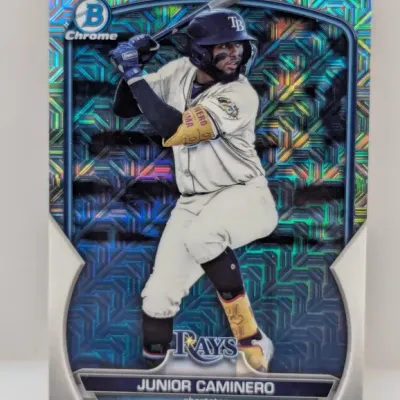 Bowman Chrome Junior Caminero Tampa Bay Rays baseball card featuring a colorful holographic refractive pattern.