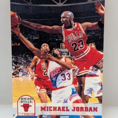 1990-91 NBA Hoops Michael Jordan #65 basketball card, featuring the Chicago Bulls logo and an action photo against the Philadelphia 76ers.