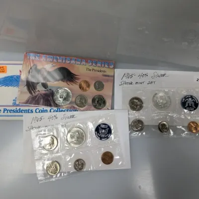 Collection of US coin sets, featuring 1965 Special Mint Sets with 40% silver Kennedy half dollars and a packaged Americana Series...