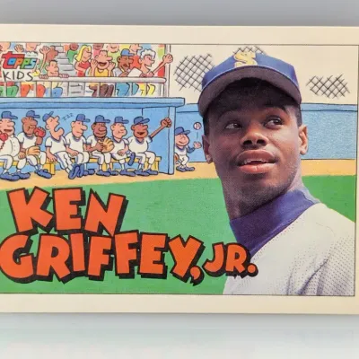 1990 Topps Kids Ken Griffey Jr. baseball card featuring cartoon artwork and a photo of the Seattle Mariners outfielder.