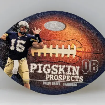 Football-shaped 2001 Fleer Hot Prospects Pigskin Prospects Drew Brees rookie trading card featuring a textured football design.