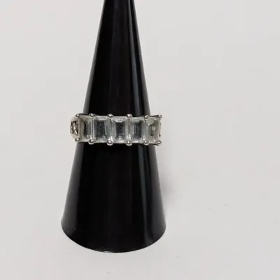Sterling silver multi-stone ring set with rectangular emerald-cut clear crystals or gemstones, displayed on a black ring cone.