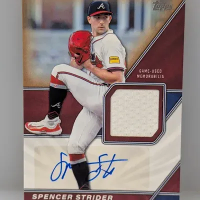 Topps Spencer Strider autographed game-used memorabilia baseball card featuring an inset uniform swatch and blue ink signature.