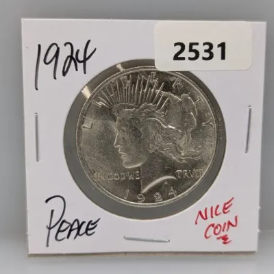 1924 Peace silver dollar coin presented in a cardboard flip holder.