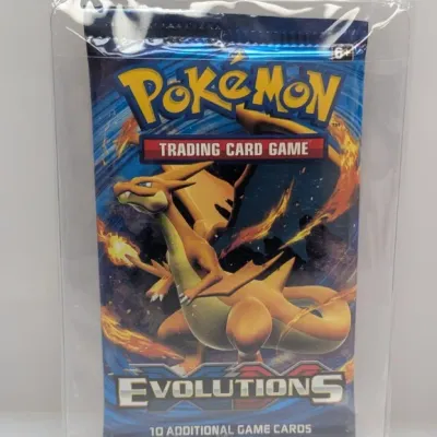 Sealed Pokémon XY Evolutions booster pack featuring Charizard artwork, contained in a clear protective sleeve.