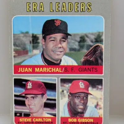 1970 Topps #61 1969 National League ERA Leaders trading card featuring Juan Marichal, Steve Carlton, and Bob Gibson.