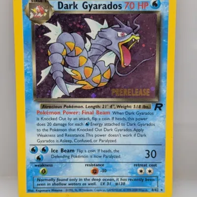 Vintage Pokémon Dark Gyarados holo trading card with gold 'Prerelease' stamp from Team Rocket set 8/82, circa 2000.