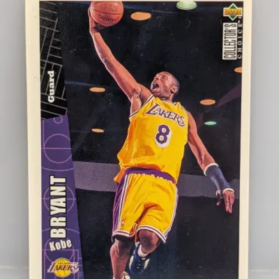 1996-97 Upper Deck Collector's Choice Kobe Bryant rookie basketball card, featuring him in his Los Angeles Lakers uniform going for...