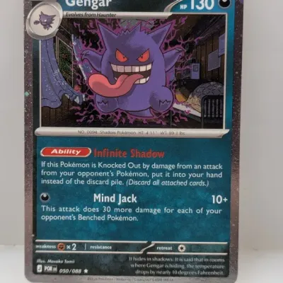 Gengar Pokémon trading card (050/088) with cosmos holo pattern border, featuring artwork by Masako Tomii.