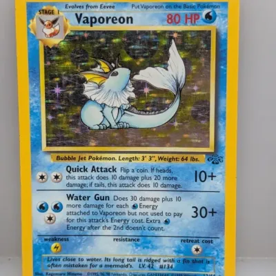 1999 Pokémon Jungle set holographic Vaporeon trading card (#12/64), featuring artwork by Kagemaru Himeno.