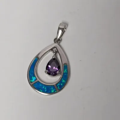 Sterling silver teardrop pendant featuring inlaid blue synthetic opal and a dangling purple faceted amethyst-colored stone center.