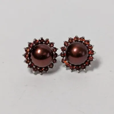Pair of brown cultured pearl stud earrings with red garnet halos set in sterling silver, in very good condition.