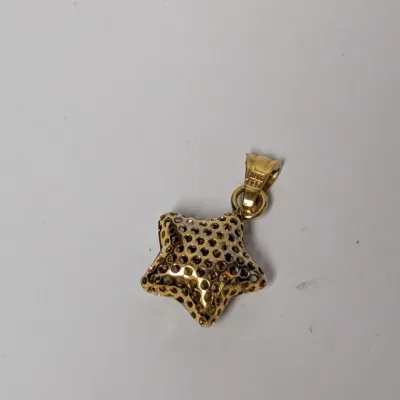 Gold-tone puff star pendant with a perforated design and attached bail.