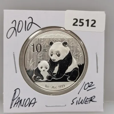 2012 Chinese Silver Panda 10 Yuan coin, containing 1 oz of .999 fine silver, presented in a cardboard coin flip.