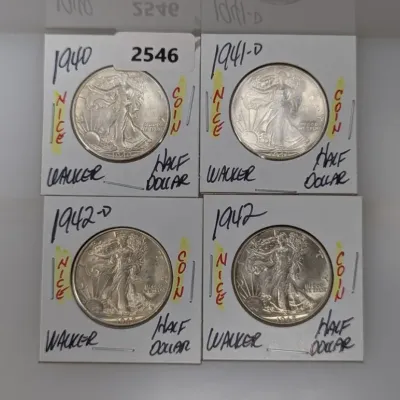 Set of four Walking Liberty silver half dollars dated 1940, 1941-D, 1942-D, and 1942, housed in individual cardboard flip holders.