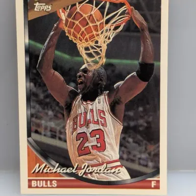 1992-93 Topps #115 Michael Jordan basketball card featuring an action shot of him dunking for the Chicago Bulls.
