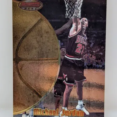 1997-98 Bowman's Best Michael Jordan basketball card featuring a metallic gold texture basketball design and an action photo in his...