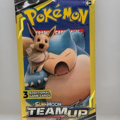 Sealed Pokémon Sun & Moon Team Up 3-card booster pack featuring Eevee and Snorlax artwork.