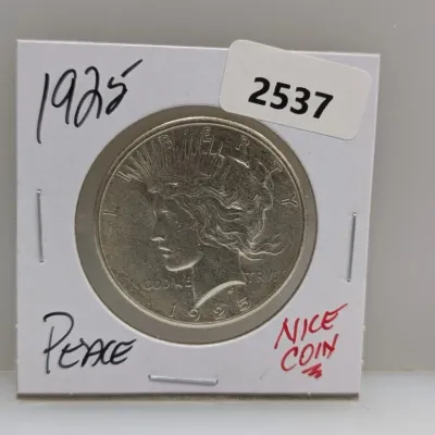 1925 Peace silver dollar housed in a cardboard coin flip holder.