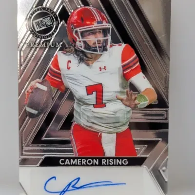 2024 Press Pass Premium Cameron Rising autographed football trading card featuring a metallic foil background and on-sticker blue ink...
