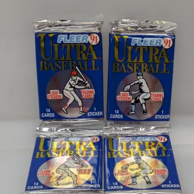 Four unopened wax packs of 1991 Fleer Ultra Baseball trading cards, each containing 14 cards and 1 logo sticker.