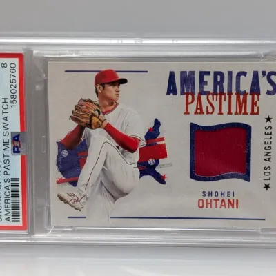PSA 8 NM-MT graded 2022 Panini Chronicles Shohei Ohtani "America's Pastime Swatch" relic baseball card in a protective slab.