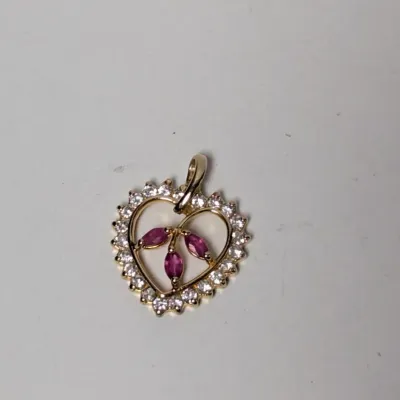 Yellow gold heart-shaped pendant featuring a diamond-set border and three marquise-cut pink gemstones in a central floral cluster.