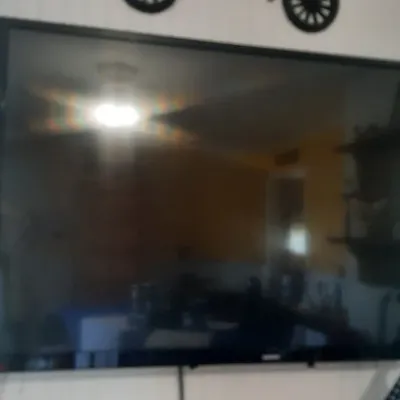 Large wall-mounted flat screen television with a thin black bezel.