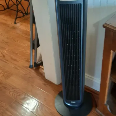 Oreck modern oscillating tower fan in dark grey and black with digital display panel.