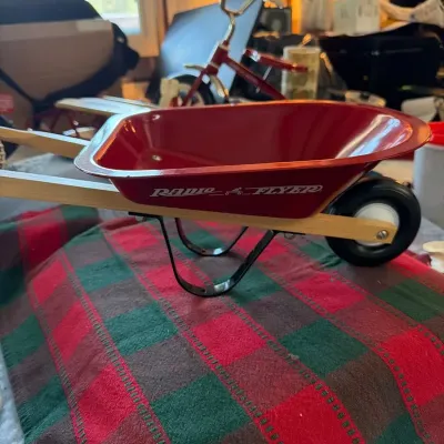 Radio Flyer “Classic Since 1917” miniature sled featuring natural wooden slats with red lettering an