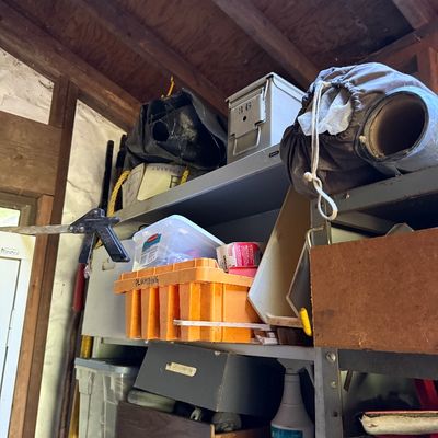 Sale Photo Thumbnail #76: Workshop storage shelves loaded with various tools, hardware, plastic totes, and a metal ammo box.
