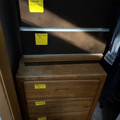 Sale Photo Thumbnail #67: Two stacked wooden dressers with labeled yellow post-it notes inside a closet space.