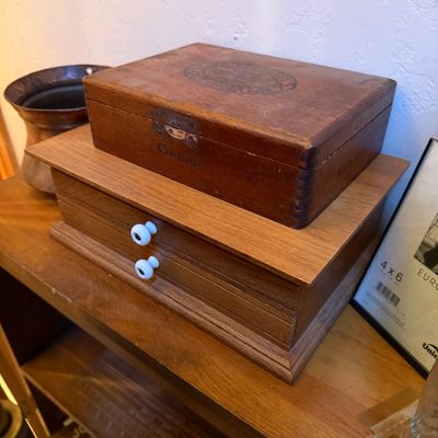Sale Photo Thumbnail #68: Vintage wooden Colonials cigar box sitting atop a small wooden desktop drawer organizer with white ceramic knobs.
