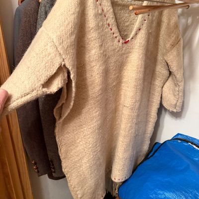 Sale Photo Thumbnail #3: Handwoven beige wool tunic or poncho featuring red accent stitching along the V-neckline and hem.