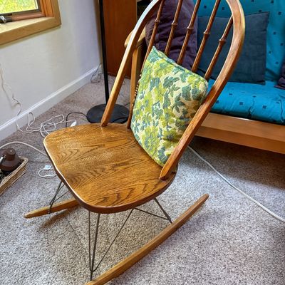 Sale Photo Thumbnail #15: Mid-century modern Windsor-style rocking chair featuring a solid oak seat and backrest, metal wire base struts, and wooden runners.