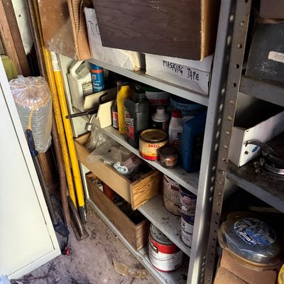 Sale Photo Thumbnail #79: Metal garage shelving unit packed with assorted vintage paint cans, motor oil bottles, hardware supplies, and wooden drawer inserts.