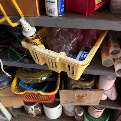Sale Photo Thumbnail #78: Workshop shelving unit organized with plastic storage baskets, hardware, paint cans, caulk tubes, and various supplies.