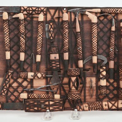 WOODEN WALL ART WITH MINIATURE TOOLS.