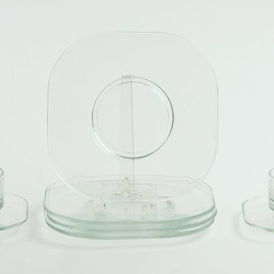 FOUR JOE COLOMBO GLASS PLATES, TEACUPS AND SAUCERS.