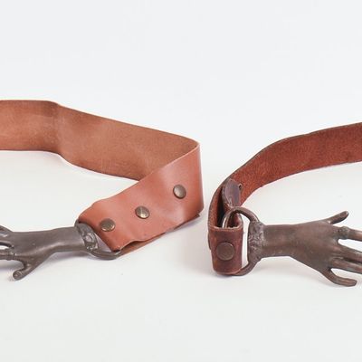 TWO BRASS AND LEATHER HAND BELTS.