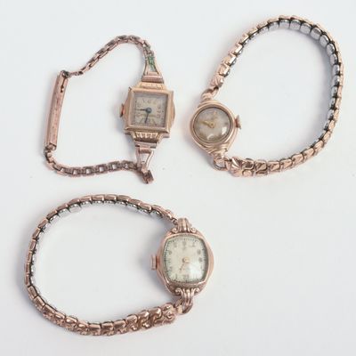 THREE ROLLED GOLD LADIES WATCHES.