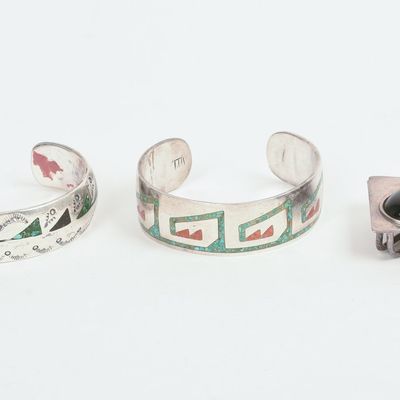TWO NAVAJO CUFF BRACELETS AND A PENDANT.